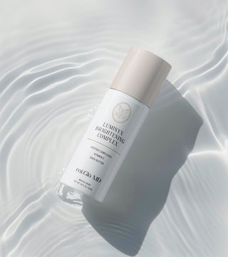 Luminyx Brightening Complex serum bottle by mi.Glō MD Skincare — hydroquinone-free dark spot corrector with tranexamic acid, niacinamide, and bakuchiol